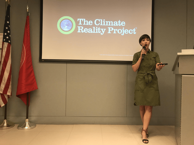 Photo of Malia Reneé Brown presenting The Climate Reality Project to LIM College